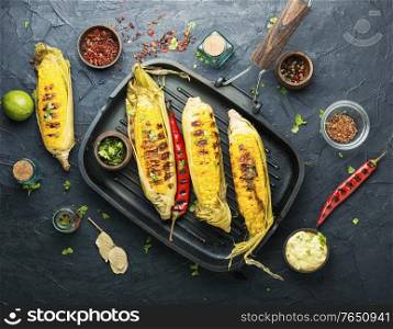 Grilled sweet corn with sauce and spicy.Summer vegan snack. Grilled sweet corn cob