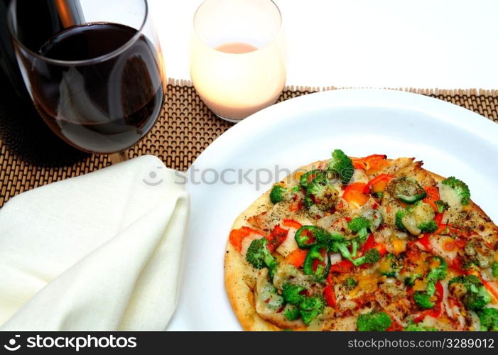 Grilled teriyaki chicken with red bell pepper, garlic, mild jalapeno pepper, broccoli, tomato, shrarp cheddar and fresh parmesan cheese and a glass of red wine.. Gourmet Chicken And Veggie Pizza