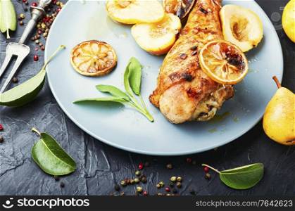 Grilled turkey leg with caramelized pear.Appetizing meat food. Baked turkey leg