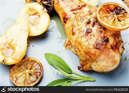 Grilled turkey leg with caramelized pear.Appetizing meat food. Roasted turkey legs with pear