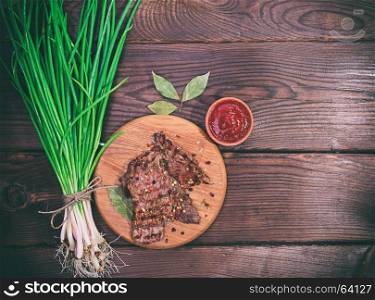 Grilled veal spices, a bunch of green onions, empty space on the right