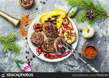 Grilled veal with vegetables.Christmas food.Beef in pomegranate sauce.Holiday food. Christmas grilled meat