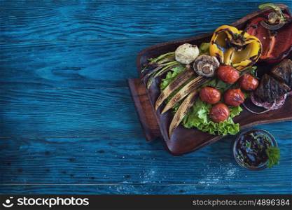Grilled vegetable at plate. Grilled vegetable on a blue wooden background