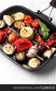 Grilled vegetables in a frying pan. Grilled vegetables in a frying pan on light background