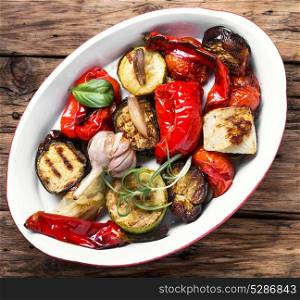 Grilled vegetables in dish. Grilled vegetables in pan on vintage wooden background
