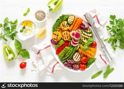 Grilled vegetables on a white plate, top view