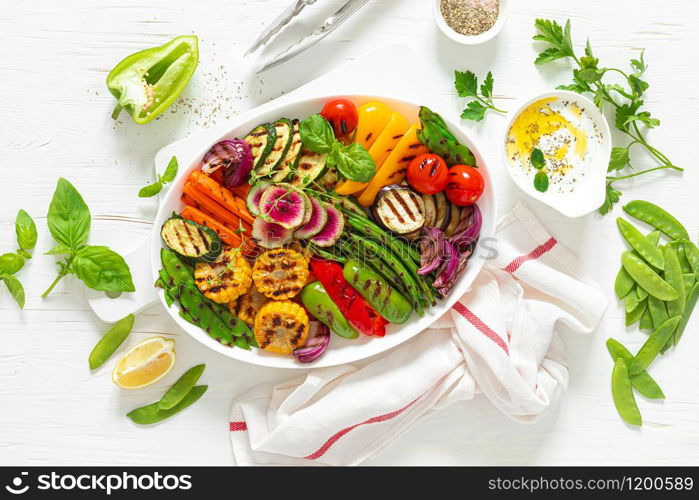 Grilled vegetables on a white plate, top view