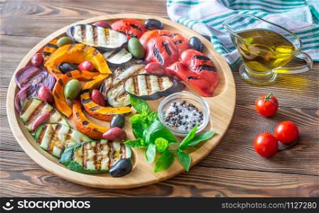 Grilled vegetables on the wooden tray: top view