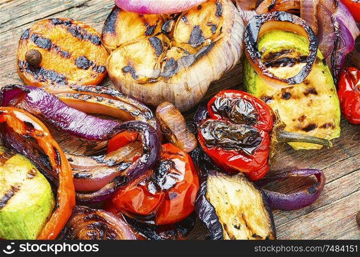 Grilled vegetables on wooden table.Large portion of grilled vegetables. Background of grilled vegetables