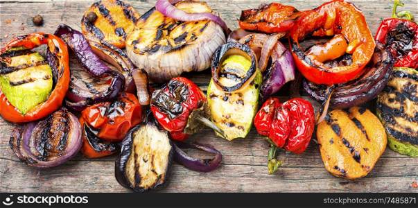 Grilled vegetables on wooden table.Large portion of grilled vegetables. Grilled vegetables mix