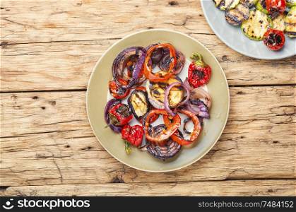 Grilled vegetables on wooden table.Large portion of grilled vegetables. Grilled vegetables on a plate