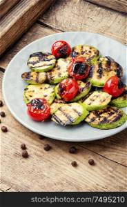 Grilled vegetables on wooden table.Large portion of grilled vegetables. Grilled vegetables on a plate