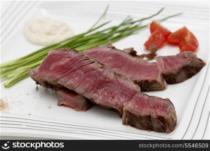Grilled wagyu rump steak, served with chives, cherry tomatoes, sea salt, and horseradish source. This is the most expensive gourmet beef in the world so the presentation concentrates on enhancing it rather than drowning the flavours.