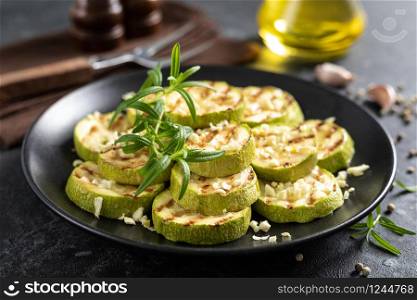 Grilled zucchini, courgette with garlic and rosemary on plate