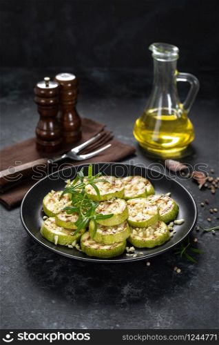 Grilled zucchini, courgette with garlic and rosemary on plate
