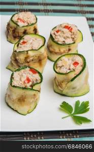 Grilled zucchini rolls with curd cheese and tuna on plate. Top view with copy space