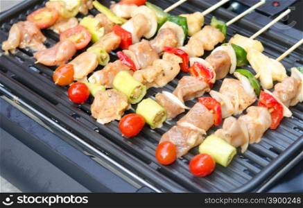 Grilling chicken on barbecue grill.