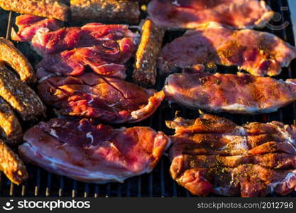 Grilling pork chops on barbecue grill. BBQ in the garden