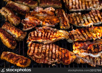 Grilling pork chops on barbecue grill. BBQ in the garden