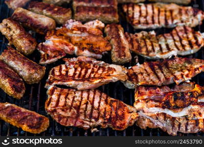 Grilling pork chops on barbecue grill. BBQ in the garden