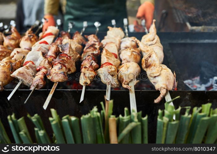 Grilling shashlik on barbecue grill with delicious meat