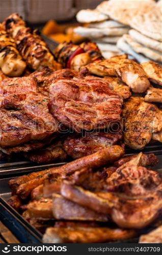 Grilling tasty food on barbecue. Steak, sausages on grill at food festival
