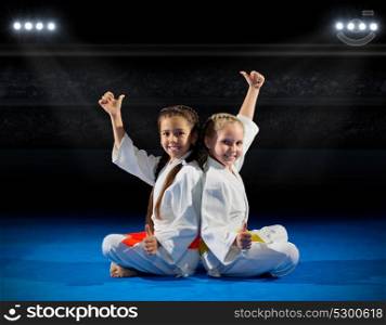 Grils martial arts fighters at sports hall