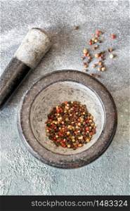Grinding of peppercorn mix in granite mortar