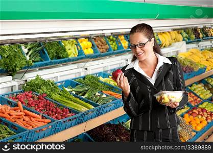 Grocery store shopping - Business woman holding apple and fruit salad