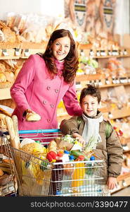 Grocery store shopping - Happy woman and child in a supermarket