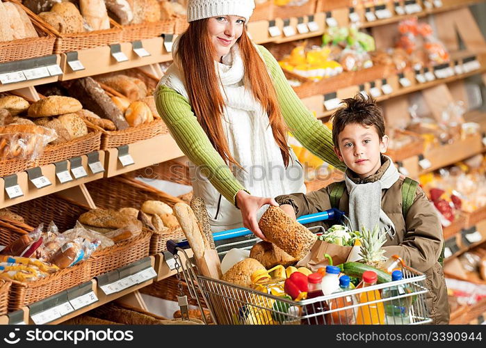 Grocery store shopping - Happy woman with child choosing bread