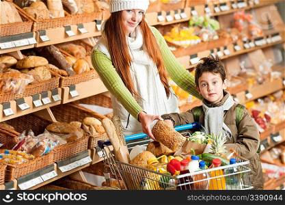 Grocery store shopping - Happy woman with child choosing bread