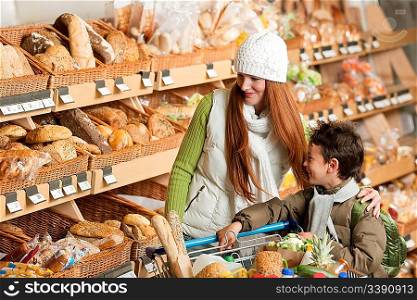 Grocery store shopping - Happy woman with child in a supermarket