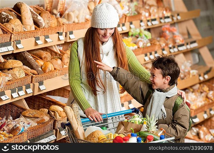 Grocery store shopping - Long red hair woman with child in a grocery store