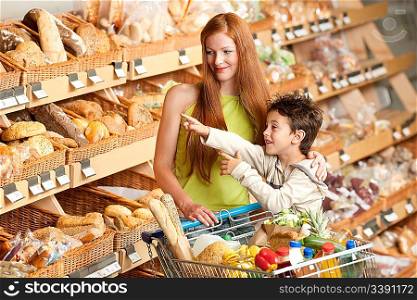 Grocery store shopping - Red hair woman and child with a shopping cart