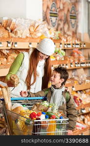 Grocery store shopping - Red hair woman with child in a supermarket