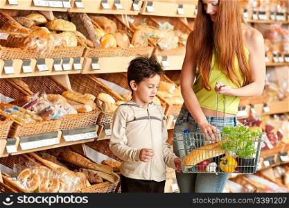 Grocery store shopping - Red hair woman with child in a supermarket