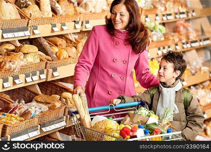 Grocery store shopping - Smiling woman with child in a supermarket