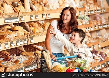 Grocery store shopping - Woman with child in a supermarket choosing bread
