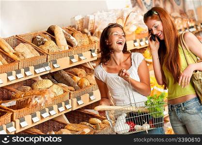 Grocery store: Two women having fun while shopping
