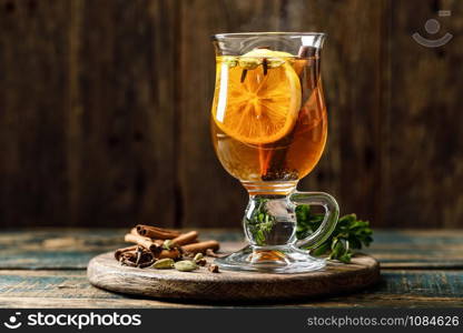 Grog. Hot drink for winter or autumn. Spicy tea and rum cocktail with lemon, cardamom, cinnamon and cloves.