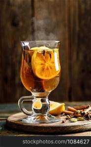 Grog. Hot drink for winter or autumn. Spicy tea and rum cocktail with lemon, cardamom, cinnamon and cloves.