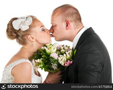 groom and bride are holding bridal bouquet and kissing, cut out from white
