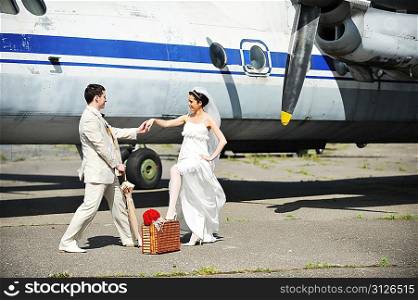 groom and bride fly to wedding travel by plane