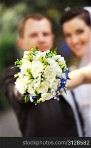 groom and bride in white dress with wedding bouquet