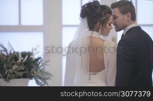 Groom and bride look to each other on their wedding day