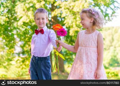 Groom gives a little girl a bouquet of flowers