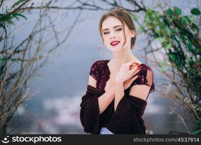 groom in a brown and bride in burgundy in the mountains Carpathians