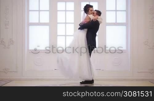 Groom meets bride, hug and whirl her in wedding day