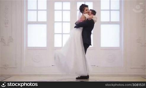 Groom meets bride, hug and whirl her in wedding day